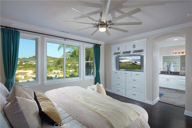 bedroom featuring ensuite bath, ceiling fan, ornamental molding, and dark wood-type flooring