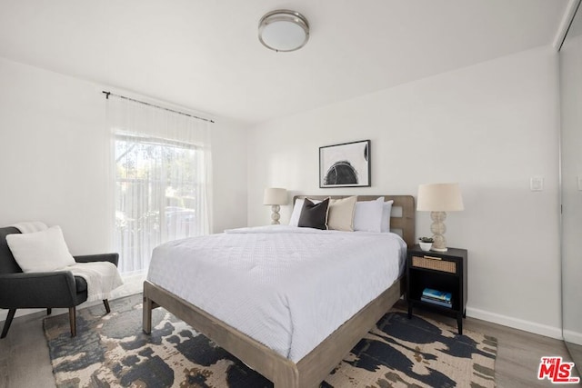 bedroom with hardwood / wood-style flooring