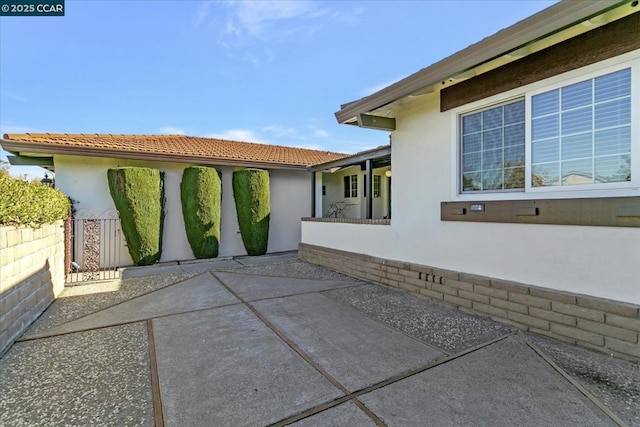 view of side of home with a patio area