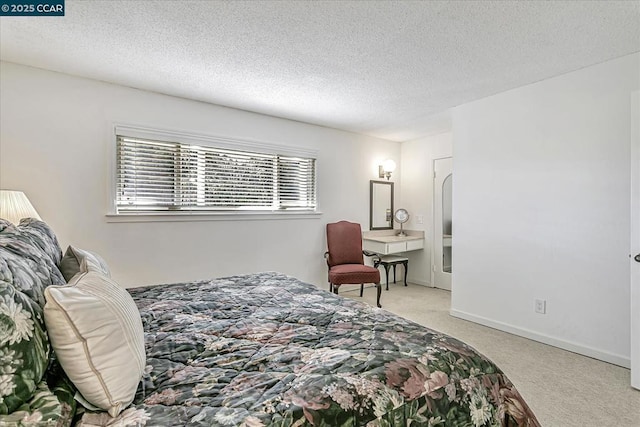 carpeted bedroom featuring a textured ceiling