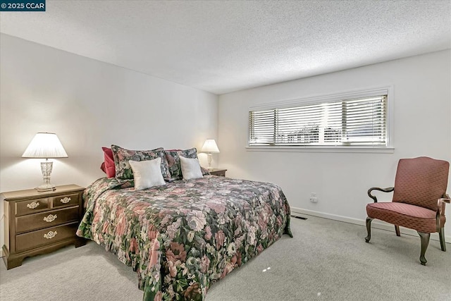 carpeted bedroom featuring a textured ceiling