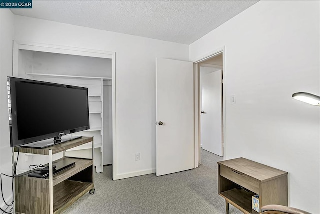 carpeted bedroom featuring a closet and a textured ceiling