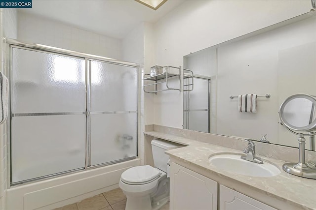 full bathroom featuring toilet, shower / bath combination with glass door, tile patterned floors, and vanity