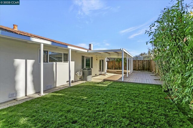 view of yard with a patio and central AC unit