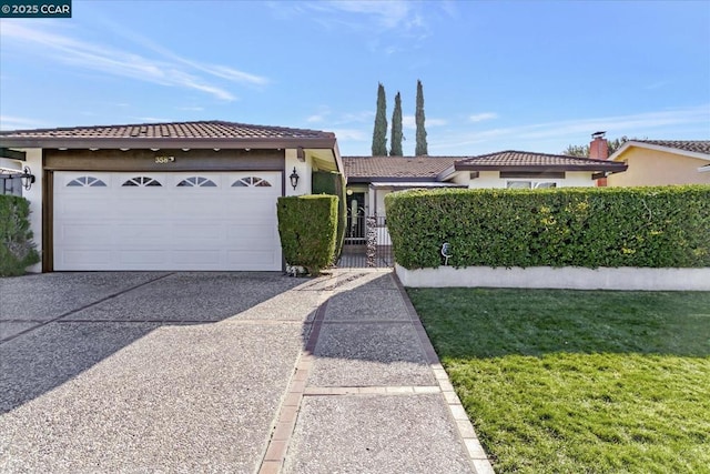 view of front of home featuring a front yard and a garage