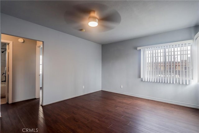 unfurnished room featuring dark hardwood / wood-style floors and ceiling fan