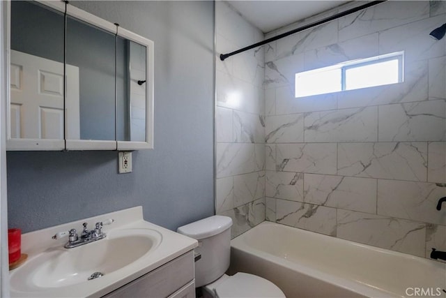 full bathroom with tiled shower / bath, vanity, and toilet