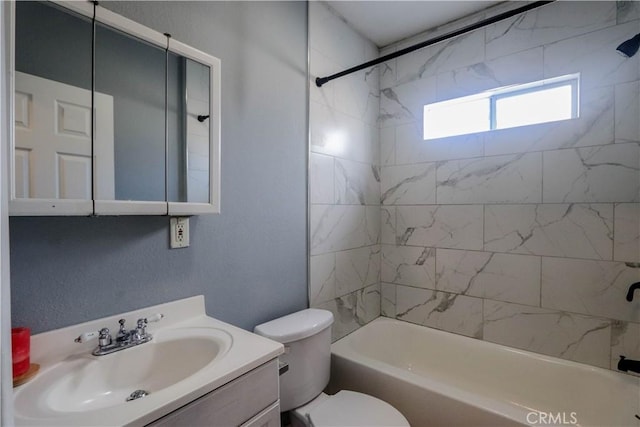 full bathroom with vanity, toilet, and tiled shower / bath combo