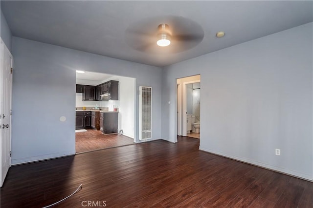 unfurnished living room featuring dark hardwood / wood-style floors and ceiling fan