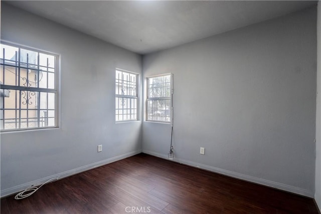 empty room featuring dark hardwood / wood-style flooring