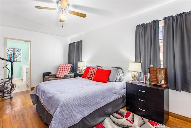 bedroom with ensuite bathroom, ceiling fan, and light hardwood / wood-style floors