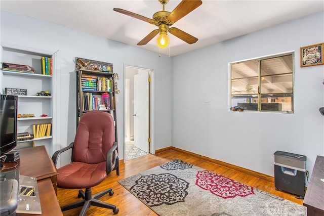 office area with ceiling fan and light hardwood / wood-style flooring