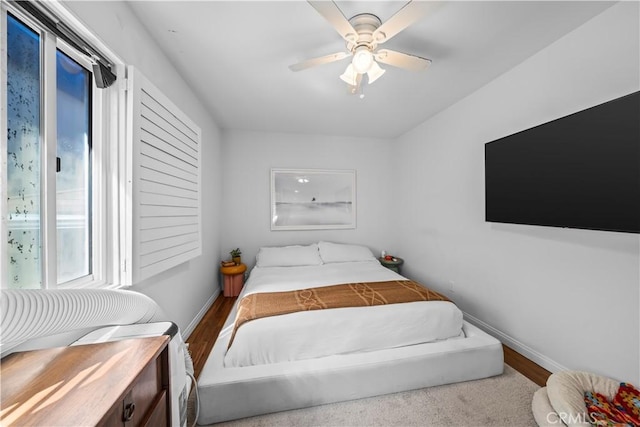 bedroom with ceiling fan and light hardwood / wood-style flooring