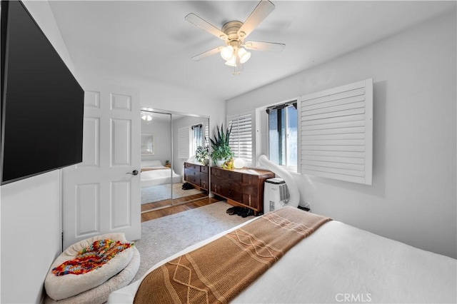 bedroom featuring hardwood / wood-style floors, a closet, and ceiling fan