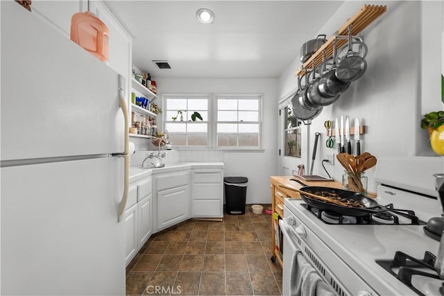 kitchen featuring white appliances and white cabinets