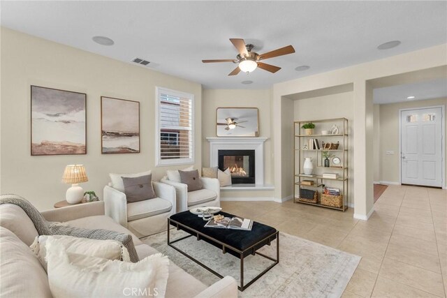 tiled living room featuring ceiling fan