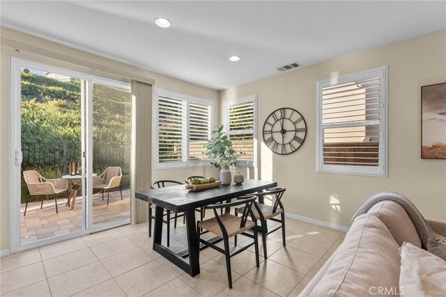 dining area featuring light tile patterned flooring