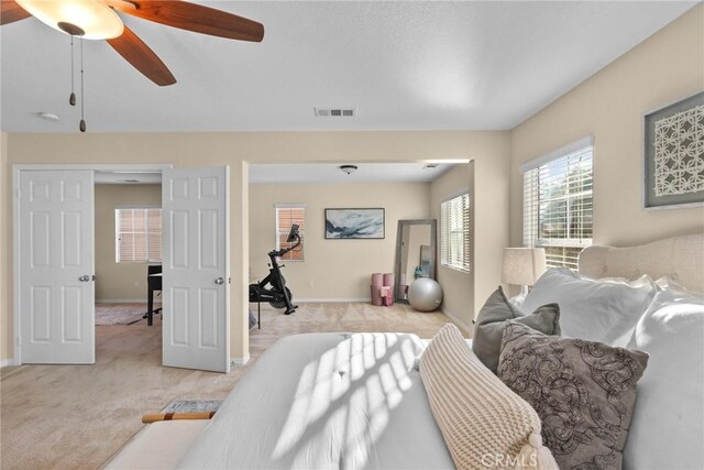 bedroom featuring ceiling fan and light colored carpet