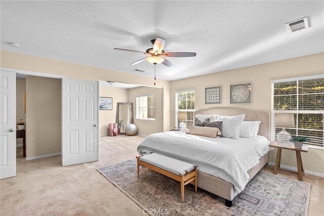 bedroom featuring ceiling fan and light colored carpet