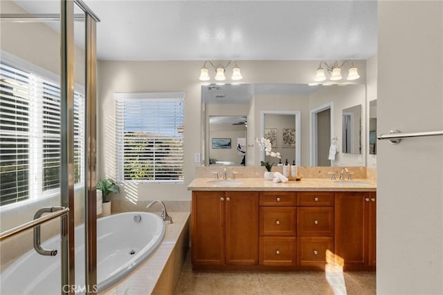 bathroom with tile patterned floors, a wealth of natural light, and vanity