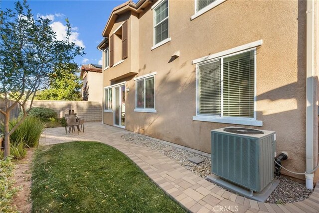 view of home's exterior featuring a patio and cooling unit