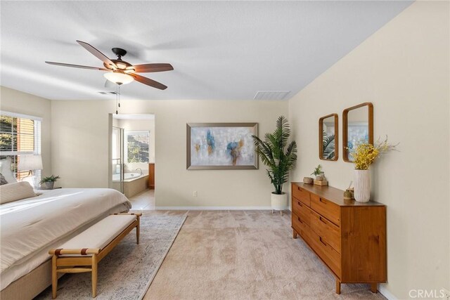 carpeted bedroom with connected bathroom and ceiling fan