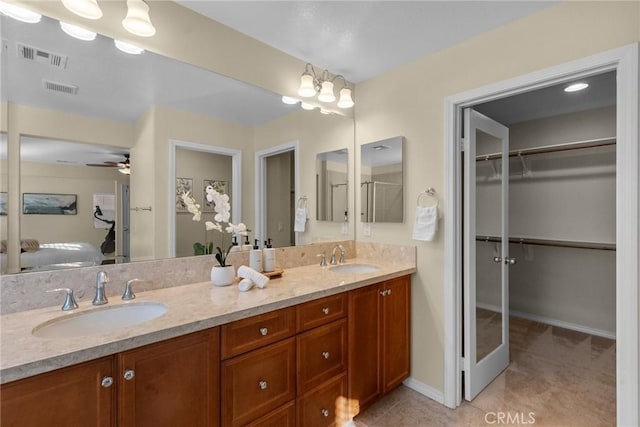 bathroom featuring ceiling fan, tile patterned floors, and vanity