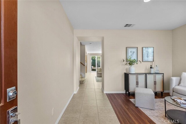 corridor featuring light tile patterned floors