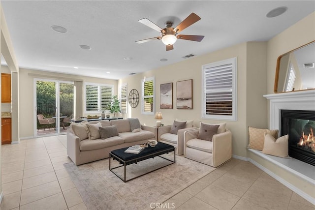 tiled living room with ceiling fan