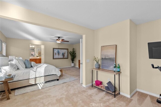 carpeted bedroom with ceiling fan and connected bathroom