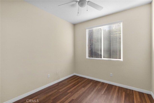 empty room with ceiling fan and dark wood-type flooring