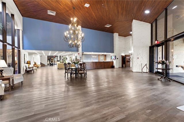 interior space with high vaulted ceiling, a notable chandelier, and wood ceiling