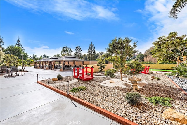 surrounding community with a patio and a gazebo