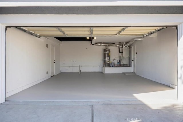 garage with heating unit and strapped water heater