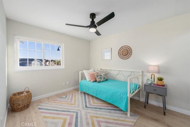 bedroom with light hardwood / wood-style floors and ceiling fan