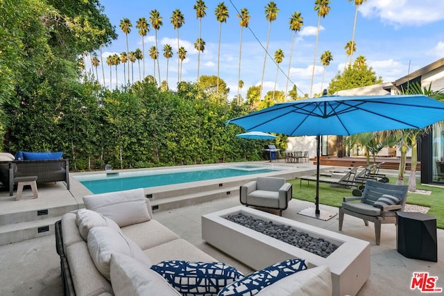 view of patio / terrace featuring an outdoor living space with a fire pit