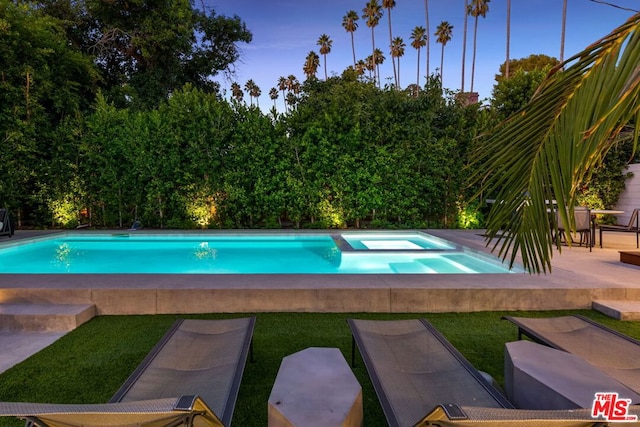 view of pool with a patio area and an in ground hot tub