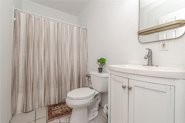 bathroom featuring toilet, tile patterned floors, walk in shower, and vanity