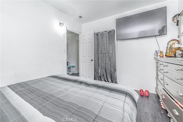 bedroom with wood-type flooring