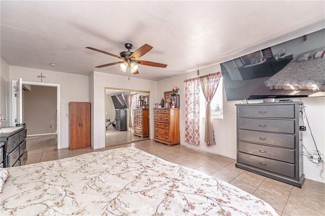 tiled bedroom featuring ceiling fan and a closet