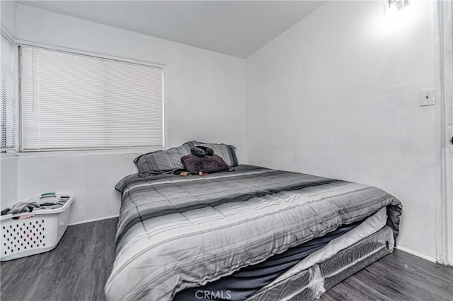 bedroom featuring dark hardwood / wood-style flooring