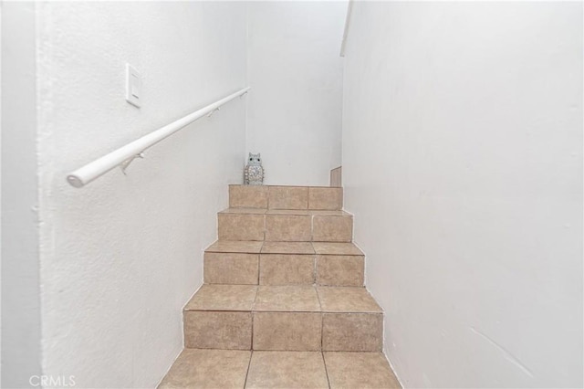 stairs featuring tile patterned floors