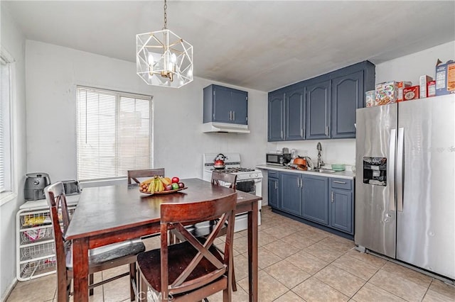 kitchen with blue cabinets, decorative light fixtures, white gas range oven, stainless steel fridge with ice dispenser, and a chandelier