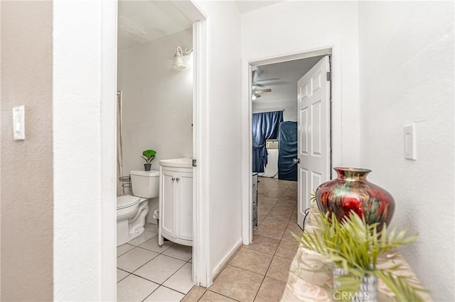 bathroom with toilet, tile patterned flooring, and ceiling fan