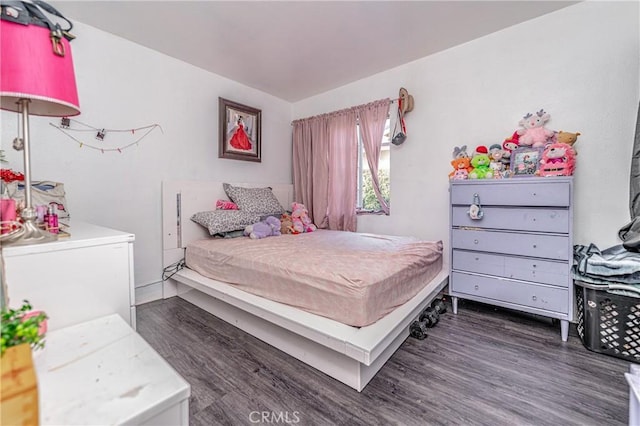 bedroom with dark hardwood / wood-style flooring