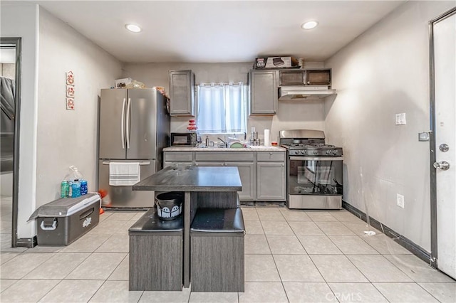 kitchen featuring a kitchen island, gray cabinetry, appliances with stainless steel finishes, light tile patterned flooring, and sink