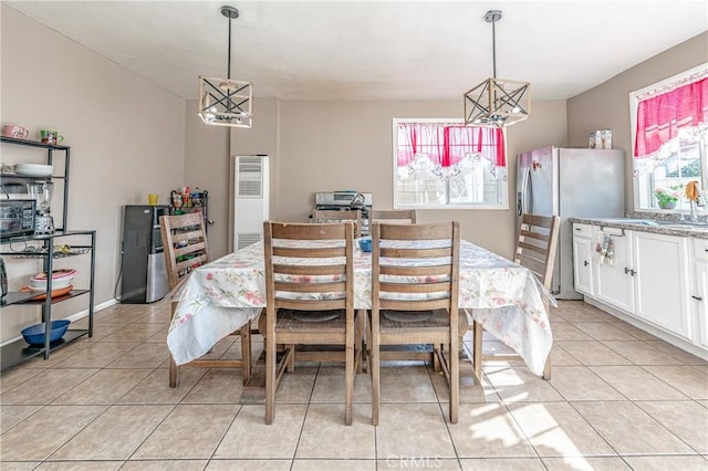 dining room with an inviting chandelier, light tile patterned floors, a wealth of natural light, and sink