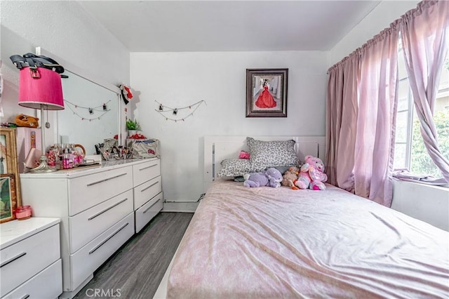 bedroom with dark wood-type flooring