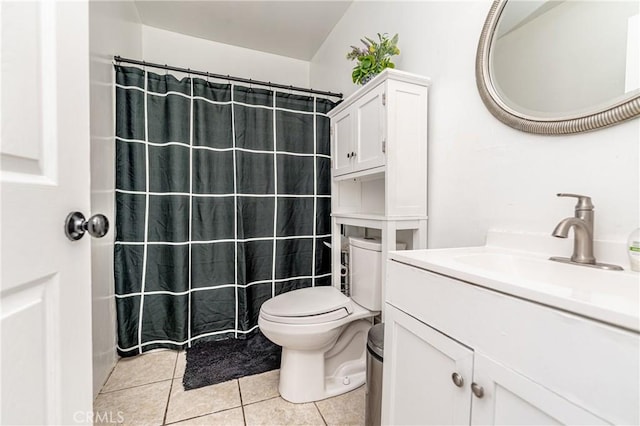 bathroom with toilet, vanity, tile patterned floors, and a shower with curtain