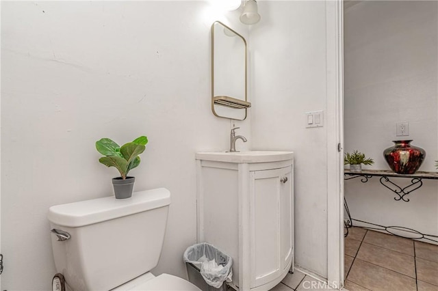 bathroom with toilet, tile patterned floors, and vanity